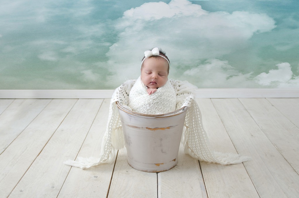 zamotana beba u deki pozira za fotografiranje kao mala beba anđeo